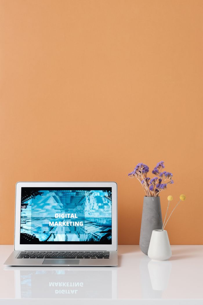 services-06 Modern workspace with laptop and decorative flowers showcasing digital marketing.